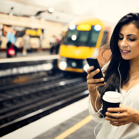girl holding her phone outdoors